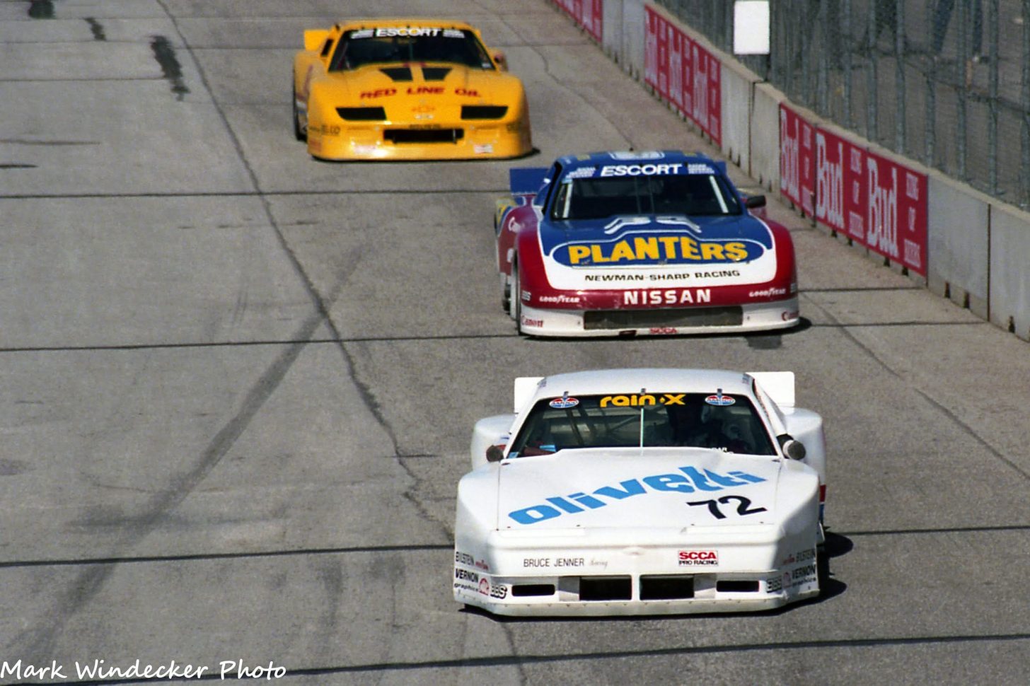 Chris Kneifel's #72 leading the Planters Newman-Sharp Nissan and a Red Line Oil Camaro on a street circuit, 1988