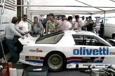 The #72 Pontiac in the team's tent, crew and visitors around the car